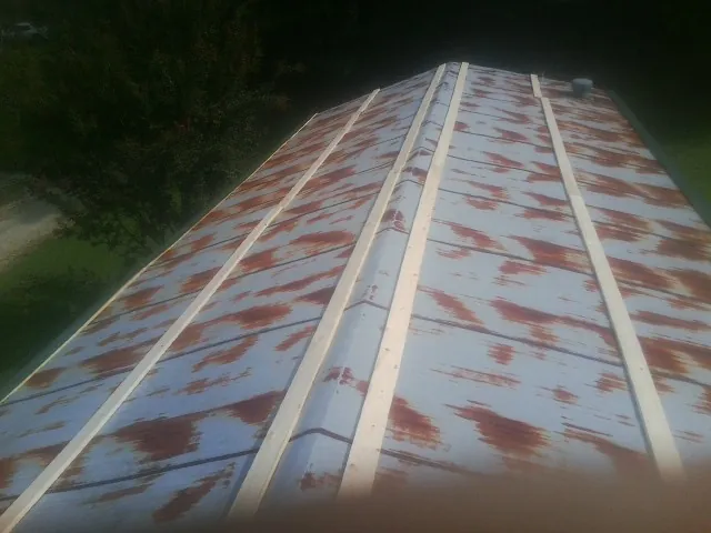 Rusted metal roof panels with new wood purlins before replacement — Storm Damage Roof Repair in San Jacinto by Roofing Brothers